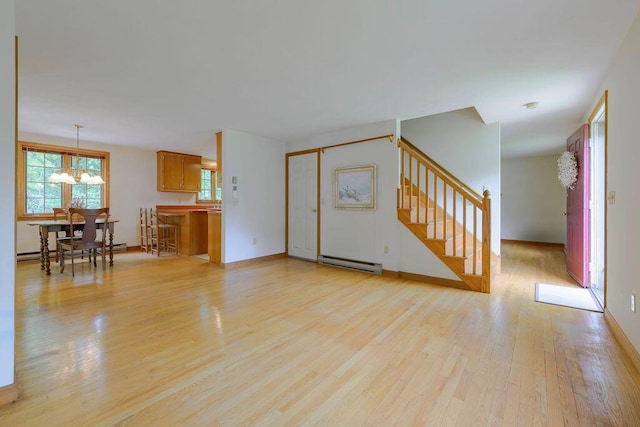 31 Woodridge Rd, East Sandwich, MA 02537 - unfurnished living room with baseboard heating, light wood-style floors, stairs, a chandelier, and baseboards