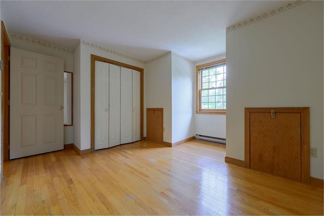 31 Woodridge Rd, East Sandwich, MA 02537 - unfurnished bedroom with baseboard heating, light wood finished floors, and baseboards