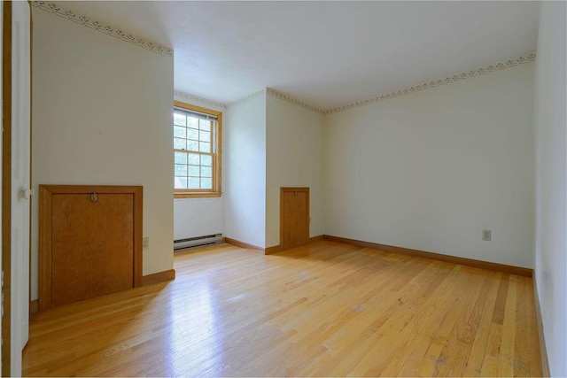 31 Woodridge Rd, East Sandwich, MA 02537 - spare room with a baseboard heating unit, light wood finished floors, and baseboards