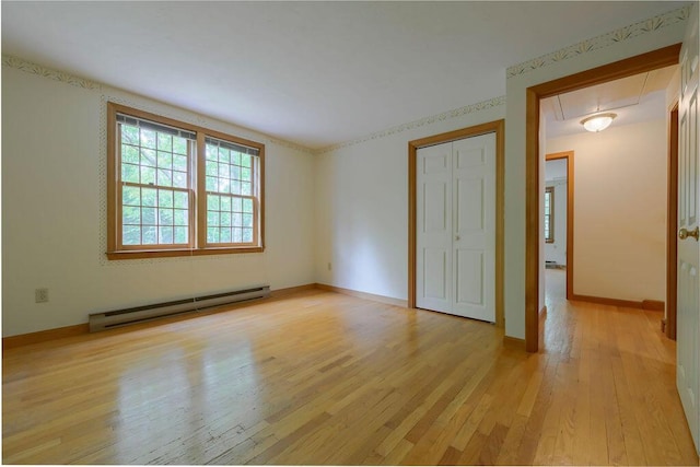 31 Woodridge Rd, East Sandwich, MA 02537 - unfurnished bedroom featuring a baseboard radiator, attic access, light wood-style flooring, a closet, and baseboards