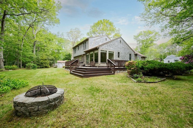 31 Woodridge Rd, East Sandwich, MA 02537 - rear view of house featuring an outdoor fire pit, a wooden deck, and a yard