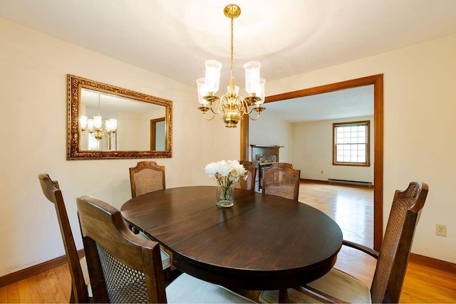 31 Woodridge Rd, East Sandwich, MA 02537 - dining space with a chandelier, light wood finished floors, baseboards, and baseboard heating