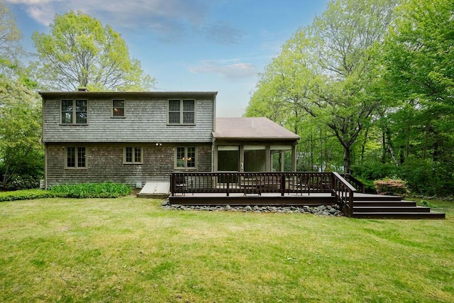 31 Woodridge Rd, East Sandwich, MA 02537 - rear view of house with a wooden deck and a yard