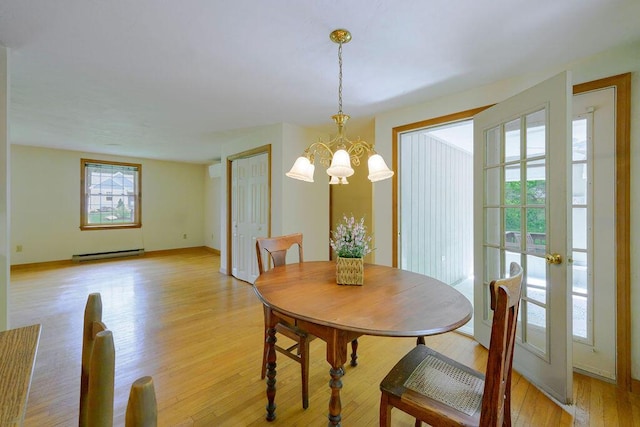 31 Woodridge Rd, East Sandwich, MA 02537 - dining space featuring baseboard heating, a chandelier, and light wood-style floors