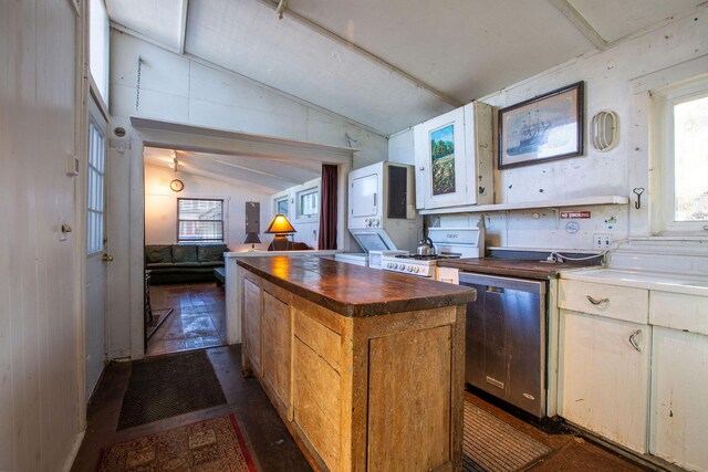 kitchen featuring dishwasher, vaulted ceiling, butcher block countertops, stove, and a kitchen island