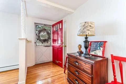 foyer with baseboard heating and light hardwood / wood-style flooring