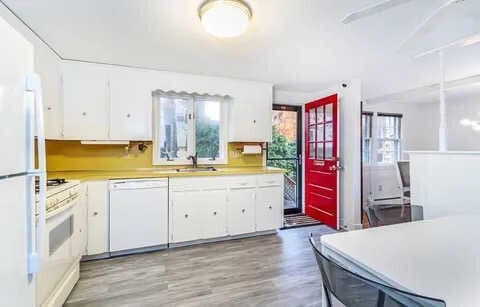 kitchen with sink, white cabinets, white appliances, and light hardwood / wood-style flooring