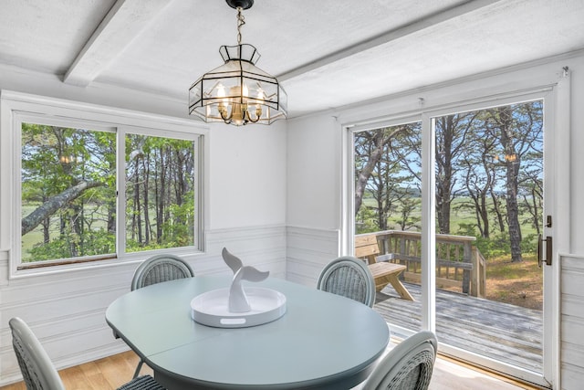 190 Meadow Ave W, Wellfleet, MA 02667 - dining room featuring beamed ceiling, light wood finished floors, a chandelier, and a textured ceiling