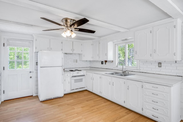 190 Meadow Ave W, Wellfleet, MA 02667 - kitchen with white appliances, healthy amount of natural light, tasteful backsplash, white cabinets, and beamed ceiling