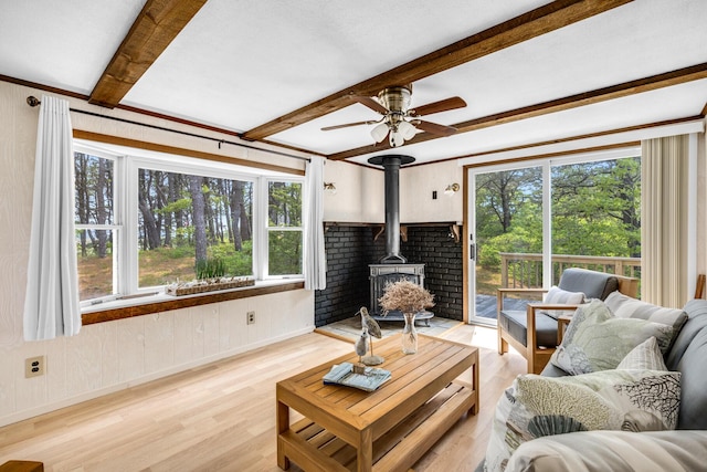 190 Meadow Ave W, Wellfleet, MA 02667 - living room with a wood stove, light wood-type flooring, ceiling fan, and beam ceiling