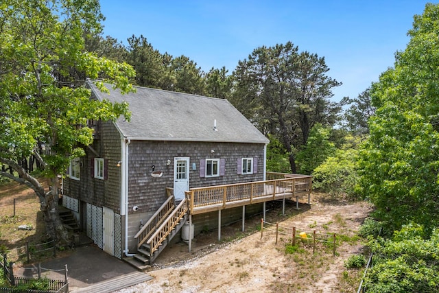 190 Meadow Ave W, Wellfleet, MA 02667 - rear view of property featuring stairs, a wooden deck, a shingled roof, and view of scattered trees