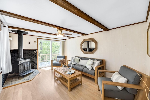 190 Meadow Ave W, Wellfleet, MA 02667 - living area with a wood stove, light wood-style flooring, beam ceiling, and ceiling fan