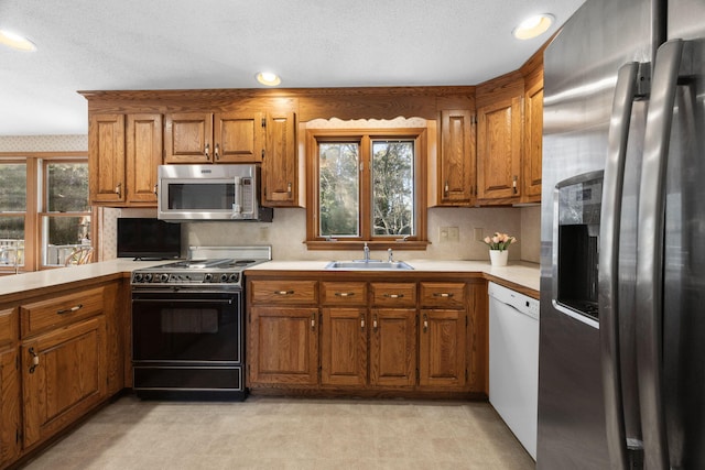 kitchen featuring sink, a textured ceiling, and appliances with stainless steel finishes