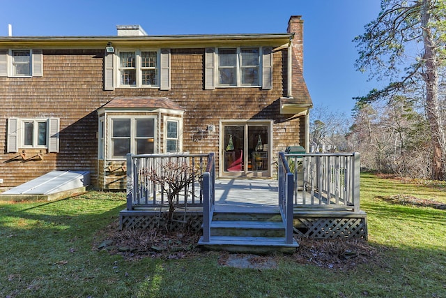 rear view of property with a lawn and a deck