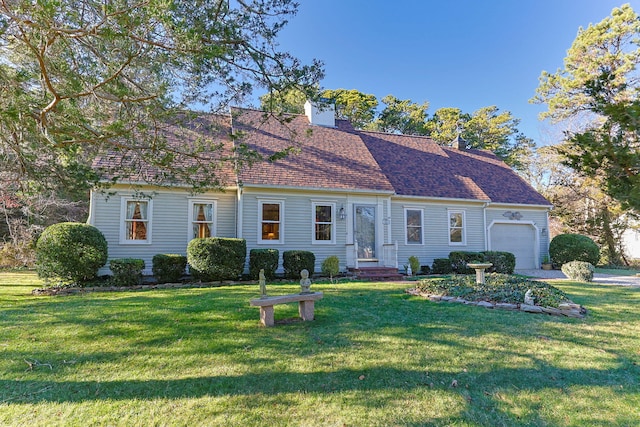 view of front of home featuring a shingled roof, a front yard, a chimney, and an attached garage