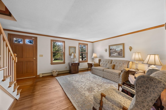 living room with light wood-type flooring, a baseboard heating unit, and ornamental molding