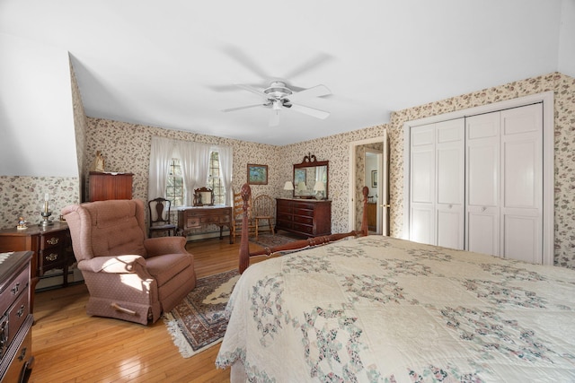 bedroom featuring baseboard heating, light wood-type flooring, a closet, and ceiling fan