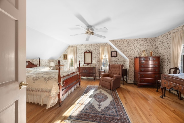 bedroom featuring hardwood / wood-style flooring, vaulted ceiling, and ceiling fan