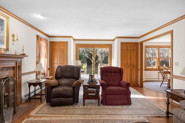 sitting room featuring light hardwood / wood-style flooring, a brick fireplace, a baseboard heating unit, and crown molding