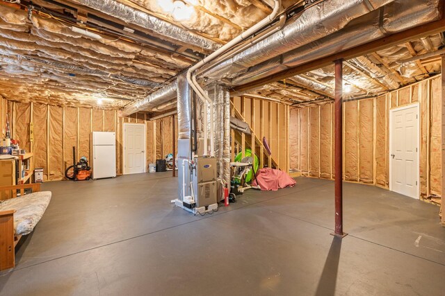 31 Seatucket Rd, East Falmouth, MA 02536 - unfinished basement with freestanding refrigerator and heating unit