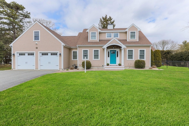 31 Seatucket Rd, East Falmouth, MA 02536 - view of front facade with a garage, aphalt driveway, fence, a front yard, and a chimney