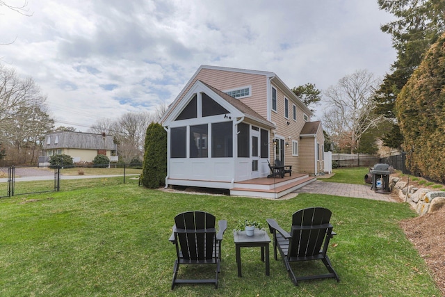 31 Seatucket Rd, East Falmouth, MA 02536 - back of property featuring a wooden deck, a fenced backyard, a sunroom, a gate, and a yard