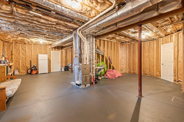 31 Seatucket Rd, East Falmouth, MA 02536 - unfinished basement with freestanding refrigerator and heating unit