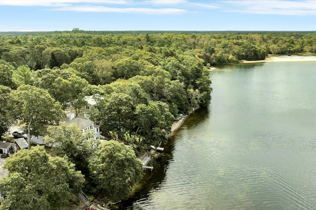 aerial view featuring a forest view and a water view