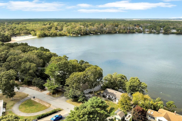 aerial view featuring a forest view and a water view