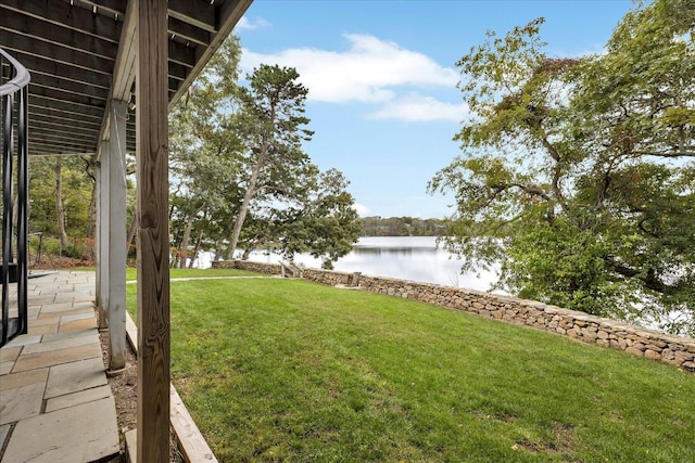 view of yard featuring a water view and a patio area