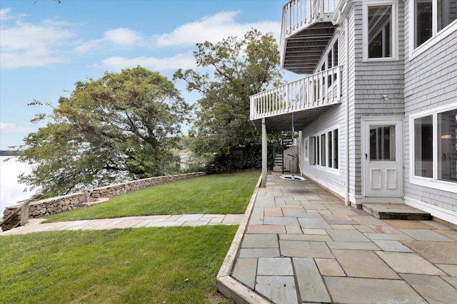 view of yard with a patio area, a deck, and stairs