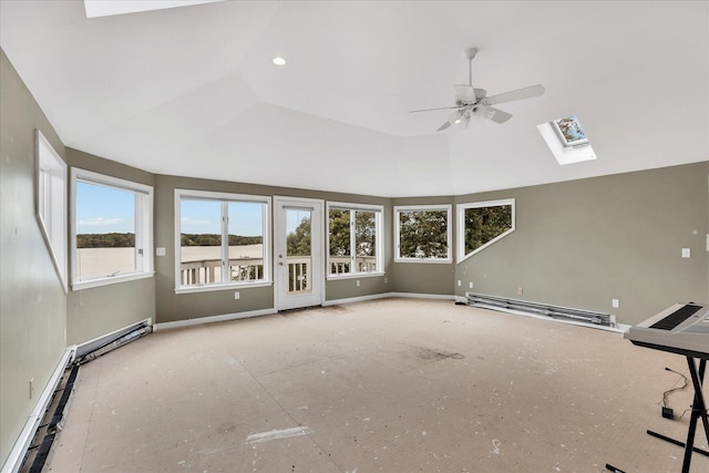 unfurnished living room featuring ceiling fan, lofted ceiling with skylight, baseboard heating, and baseboards