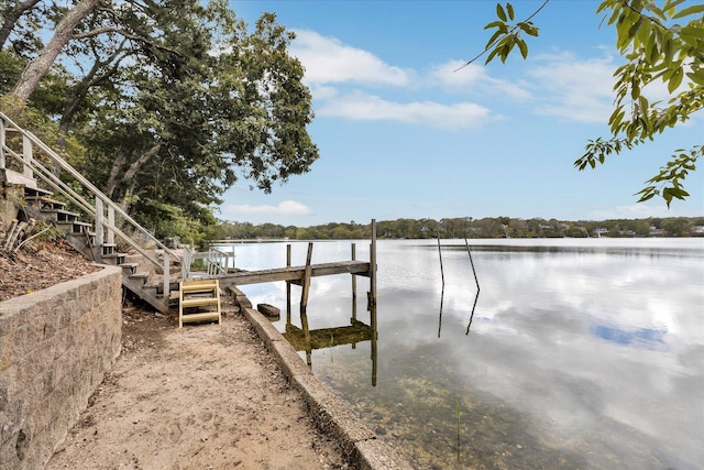 view of dock featuring stairs and a water view