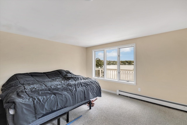 bedroom featuring carpet floors, baseboard heating, and baseboards