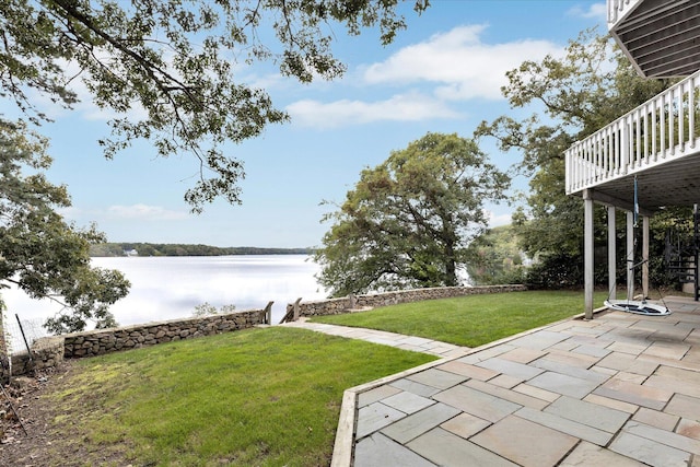 view of yard with a patio area and a deck with water view