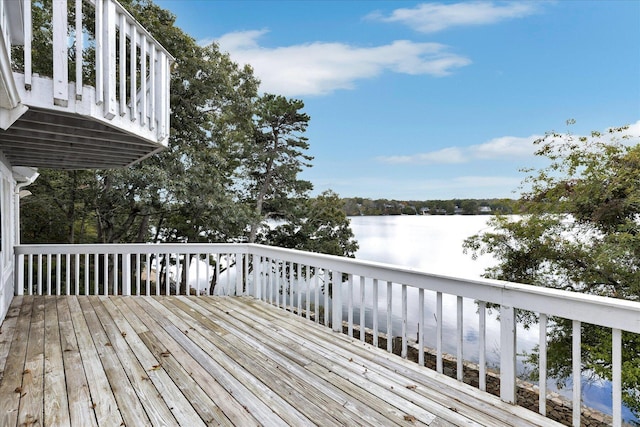 wooden terrace featuring a water view