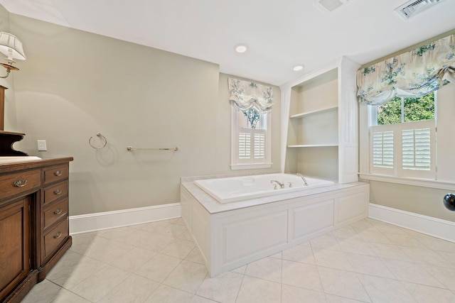 bathroom with built in shelves, a bath, and tile patterned flooring