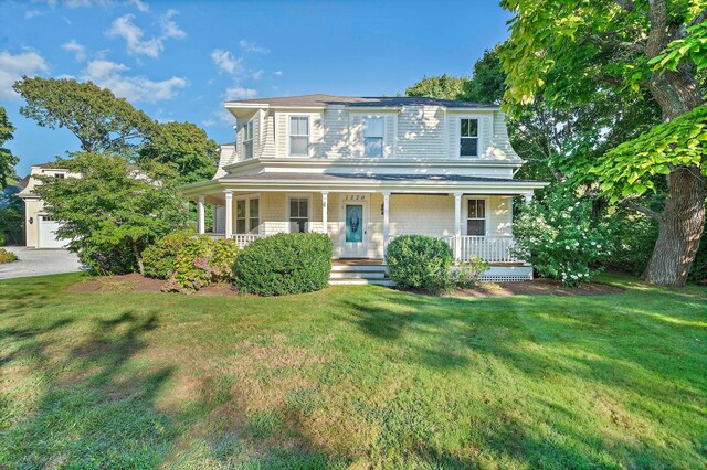 view of front of house with a front lawn and a porch