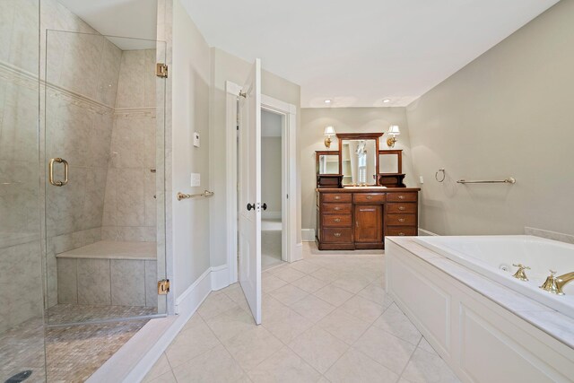 bathroom with independent shower and bath, tile patterned floors, and vanity