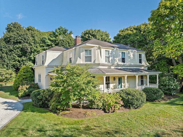 view of front of house with covered porch and a front yard