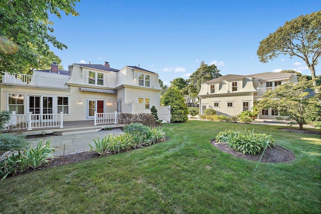 rear view of property with a lawn