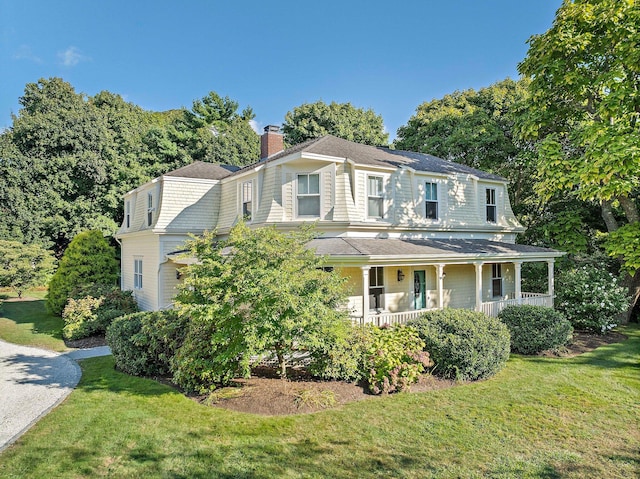 view of front of house with a porch and a front yard