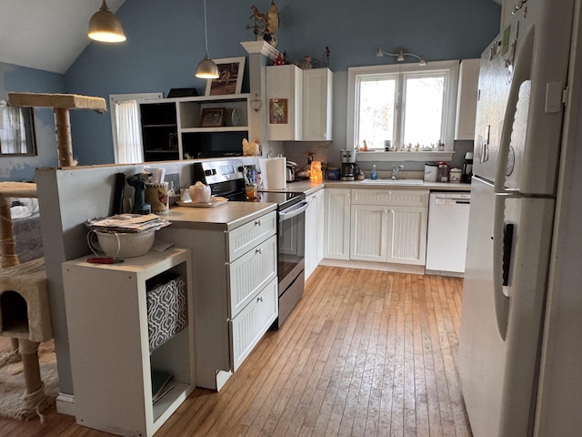 kitchen featuring white cabinetry, decorative light fixtures, white appliances, and light hardwood / wood-style flooring