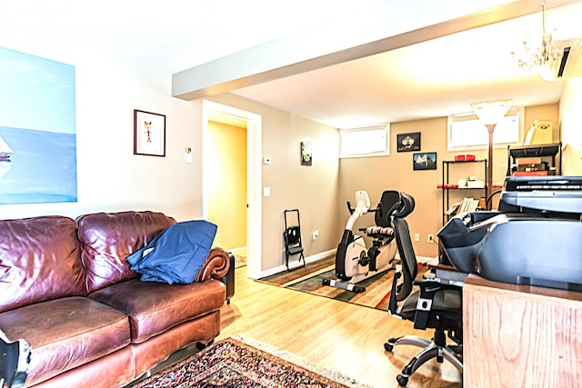 office space featuring an inviting chandelier, baseboards, and wood finished floors