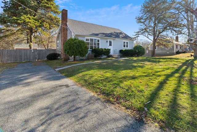 cape cod house with a front yard