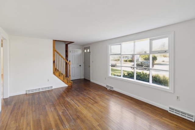 unfurnished living room with dark hardwood / wood-style flooring