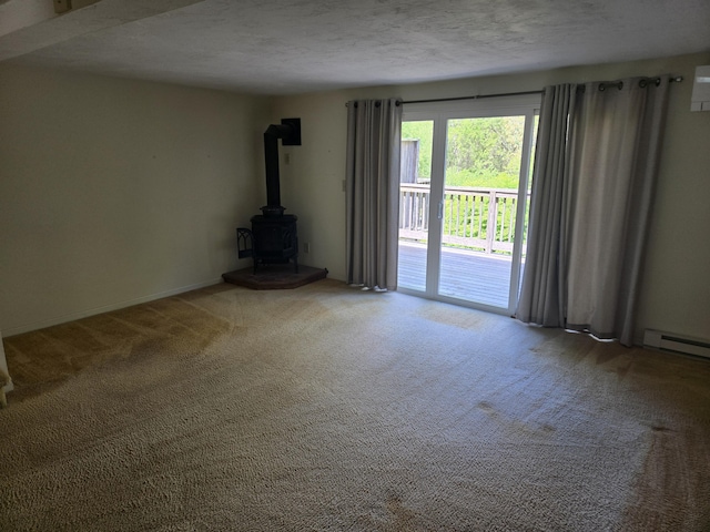 107 Court Way, Brewster, MA 02631 - unfurnished living room with carpet floors, a wood stove, and a textured ceiling