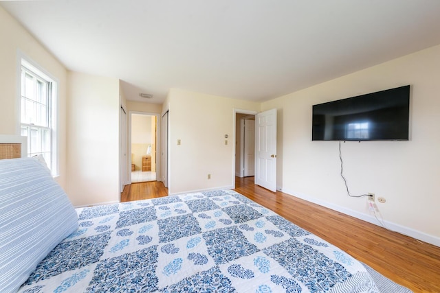 bedroom featuring baseboards and wood finished floors