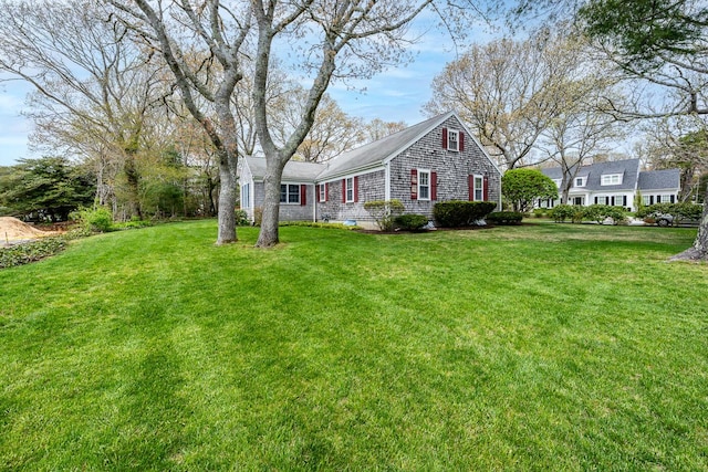 view of side of home featuring a lawn