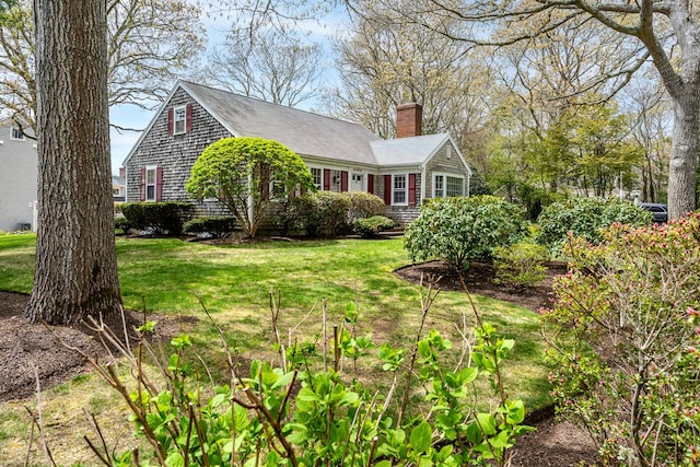 view of home's exterior with a chimney and a lawn